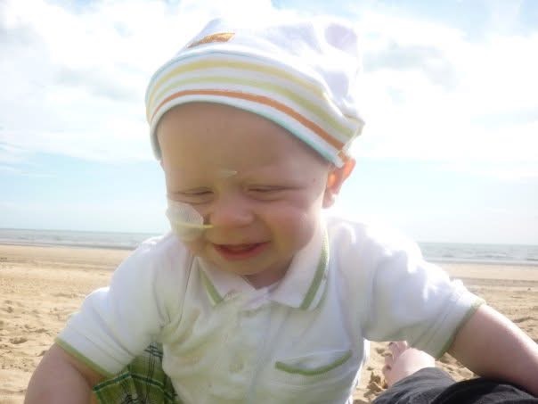 Ruddi as a toddler on a beach